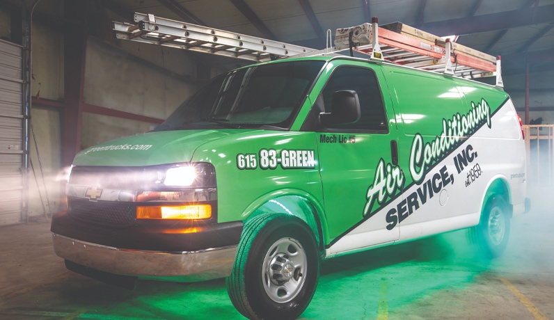 Air Conditioning Service, Inc. van with lights on and green fog.