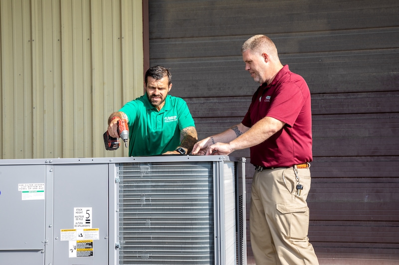 Two Air Conditioning Services team members installing a packaged unit in Brentwood, TN.